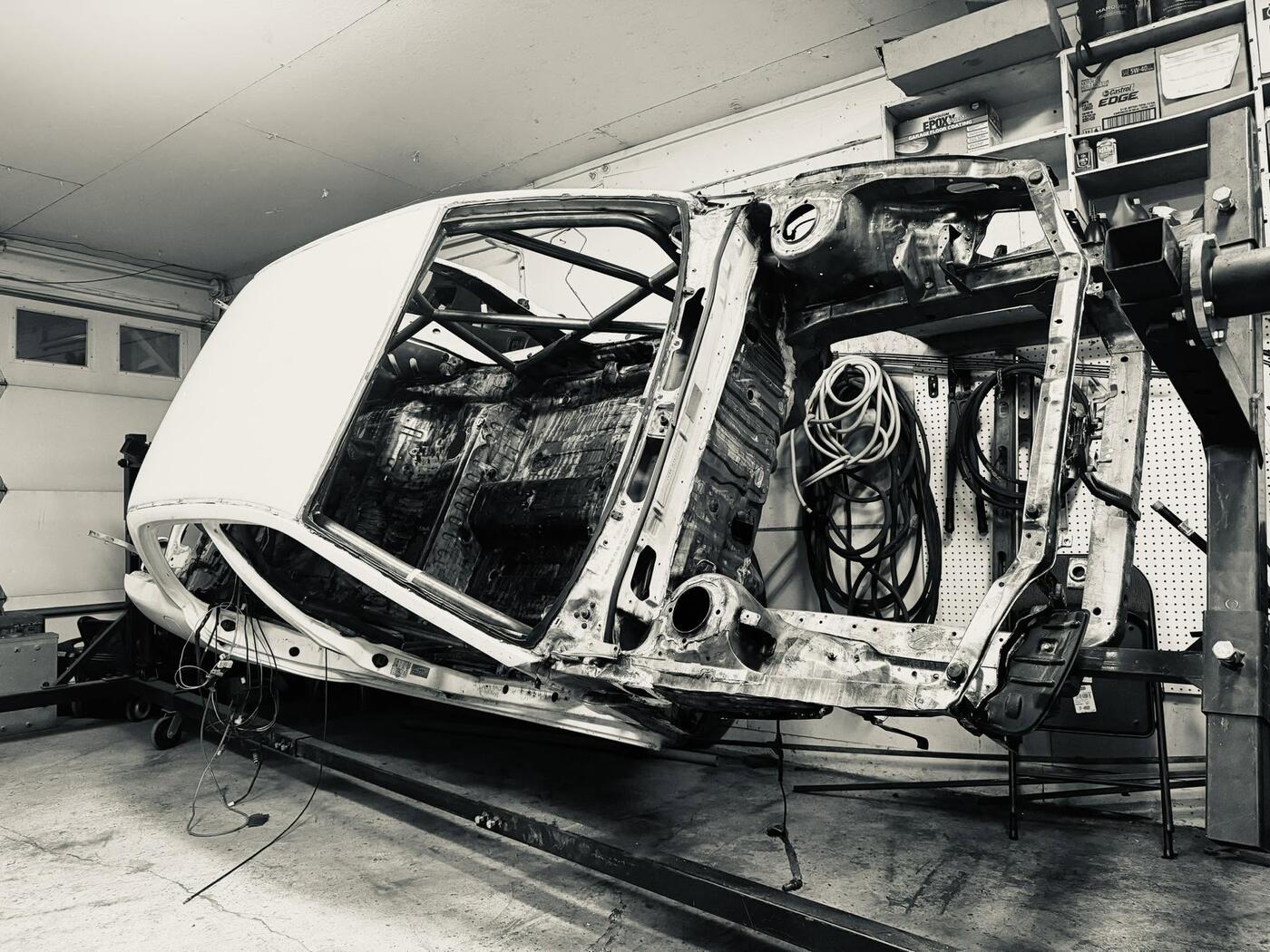 EVO III shell on rotisserie during body work stage